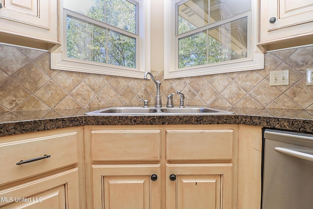 kitchen with sink, decorative backsplash, stainless steel dishwasher, and light brown cabinets