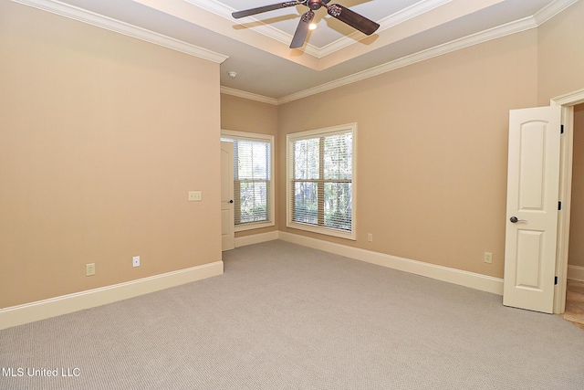 carpeted spare room with ceiling fan and crown molding