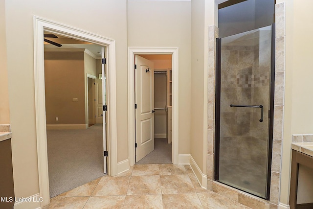 bathroom with an enclosed shower, vanity, and crown molding