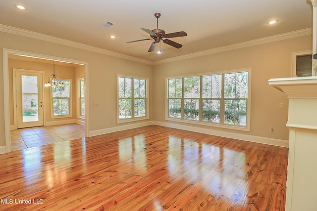 unfurnished living room with crown molding, light wood-type flooring, and ceiling fan with notable chandelier