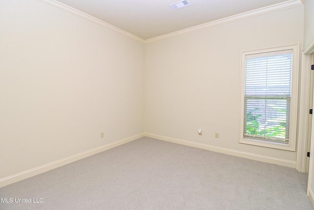 empty room with ornamental molding and light carpet