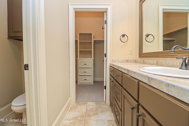 bathroom featuring toilet and vanity