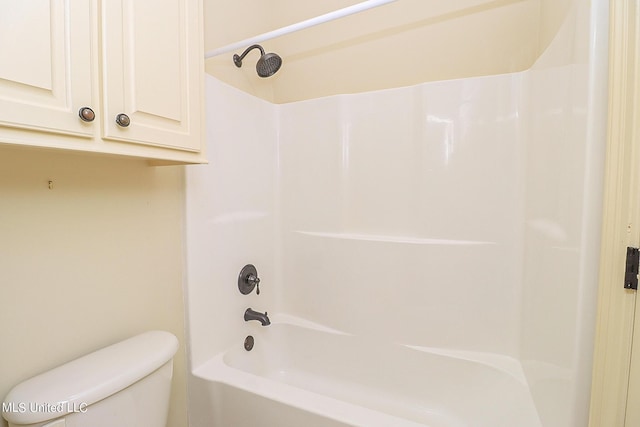 bathroom featuring toilet and bathing tub / shower combination