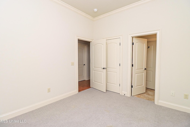 unfurnished bedroom featuring light carpet and ornamental molding