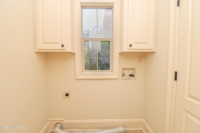 laundry area with electric dryer hookup, cabinets, washer hookup, and a wealth of natural light