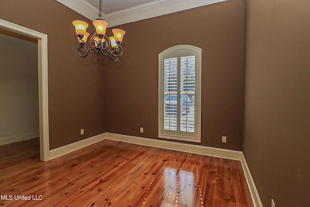 unfurnished room with a chandelier, ornamental molding, and hardwood / wood-style floors