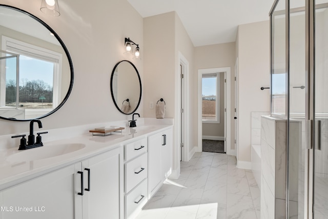 bathroom featuring a stall shower, marble finish floor, and a sink
