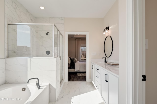 bathroom featuring a shower stall, connected bathroom, marble finish floor, double vanity, and a garden tub