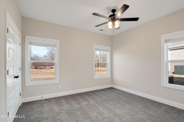 carpeted spare room featuring ceiling fan