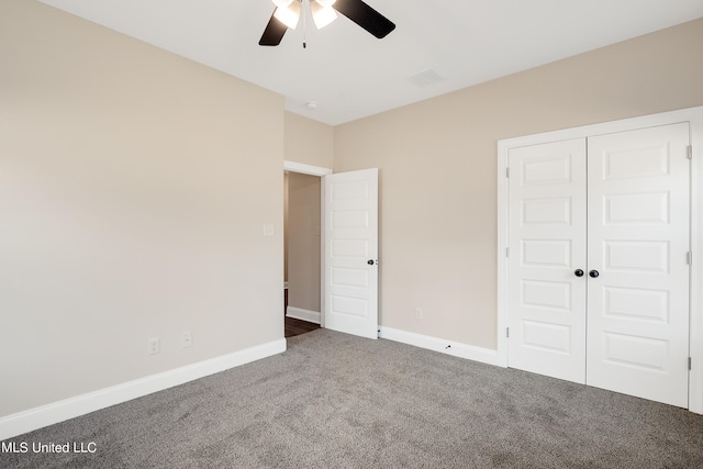 unfurnished bedroom featuring a closet, ceiling fan, and dark carpet