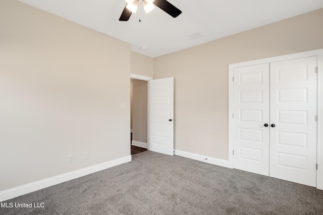 unfurnished bedroom featuring carpet flooring, a closet, ceiling fan, visible vents, and baseboards