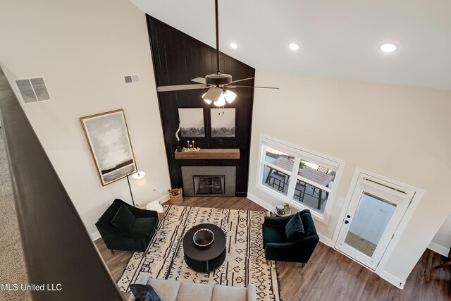 living room with high vaulted ceiling, wood-type flooring, and ceiling fan