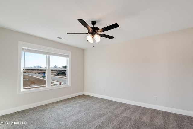 spare room with carpet and ceiling fan