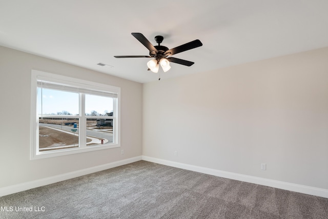 empty room with visible vents, ceiling fan, carpet flooring, and baseboards