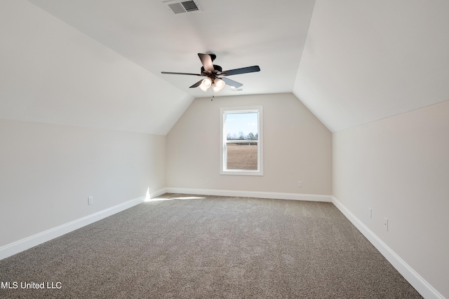 additional living space with visible vents, ceiling fan, carpet floors, and vaulted ceiling