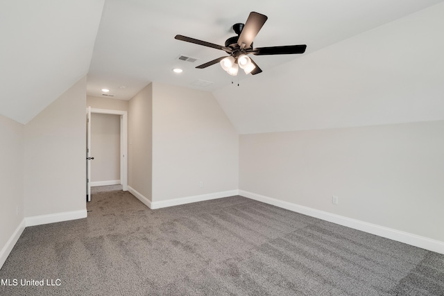 additional living space with carpet floors, vaulted ceiling, ceiling fan, baseboards, and visible vents