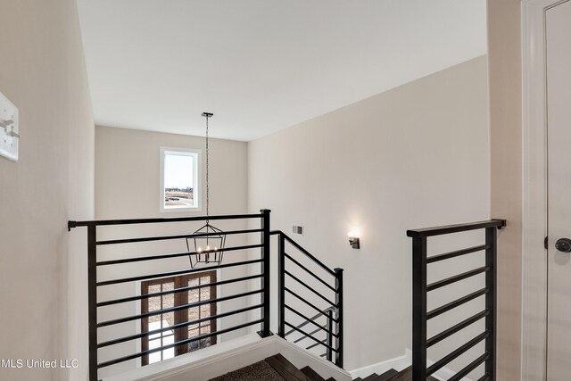 stairway with a chandelier