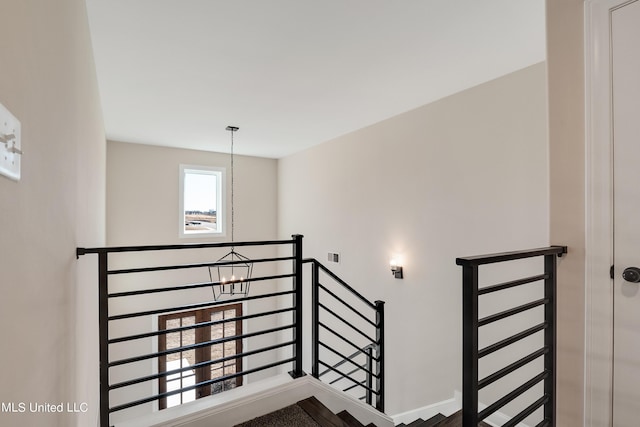 staircase with baseboards and visible vents