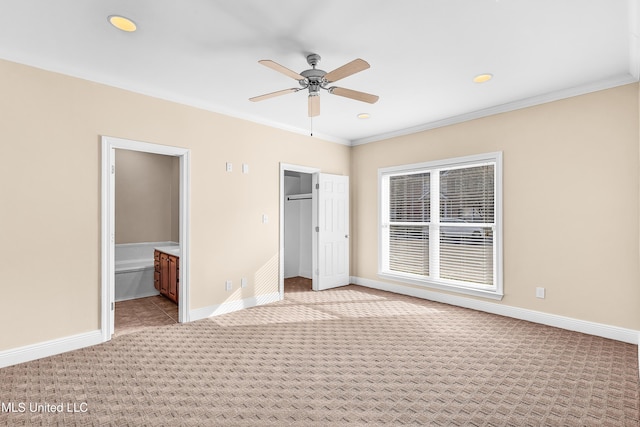 unfurnished bedroom with ceiling fan, light colored carpet, crown molding, and connected bathroom