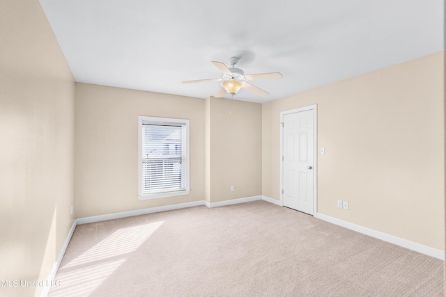 carpeted empty room featuring ceiling fan