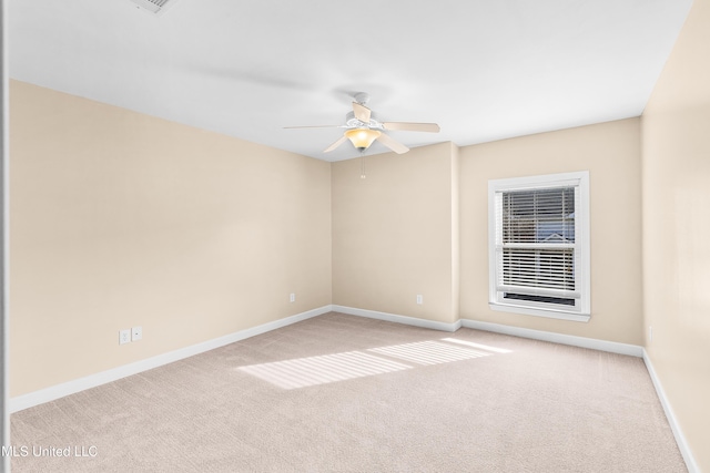 spare room featuring ceiling fan and light carpet