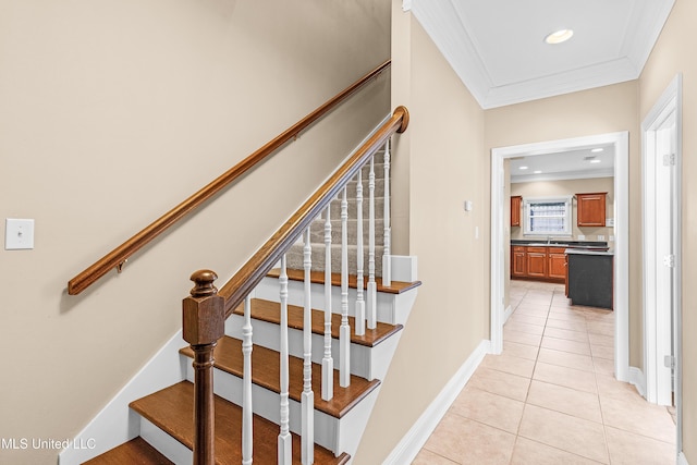 staircase featuring sink, tile patterned floors, and ornamental molding