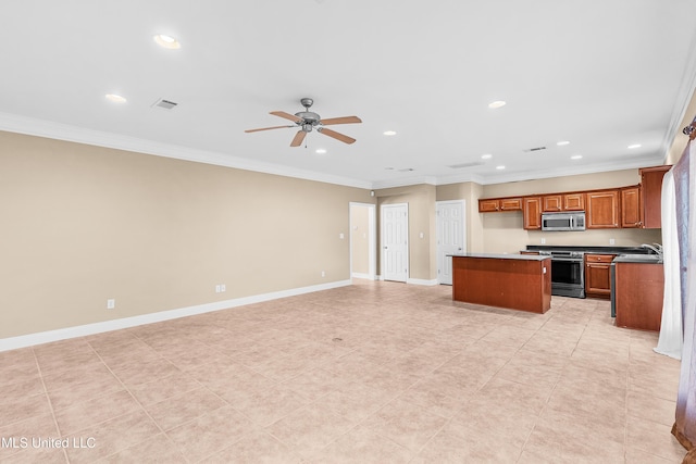 kitchen featuring ceiling fan, ornamental molding, stainless steel appliances, and a kitchen island