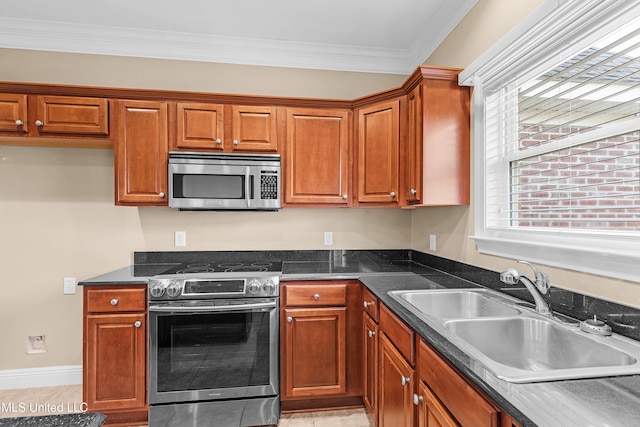 kitchen with light tile patterned floors, appliances with stainless steel finishes, crown molding, and sink