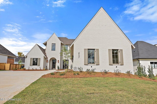 french country home featuring a front yard