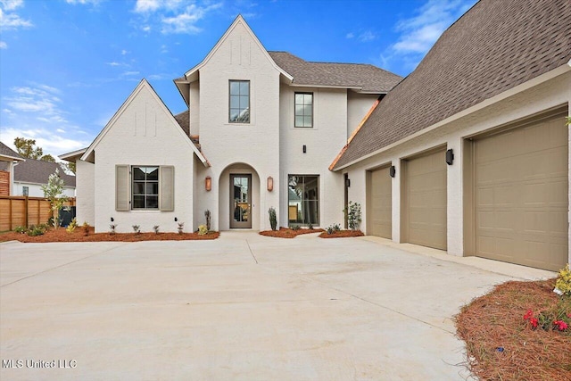 view of front of home featuring central AC unit and a garage