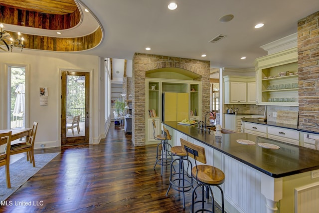 kitchen featuring dark countertops, open shelves, freestanding refrigerator, dark wood-style flooring, and recessed lighting
