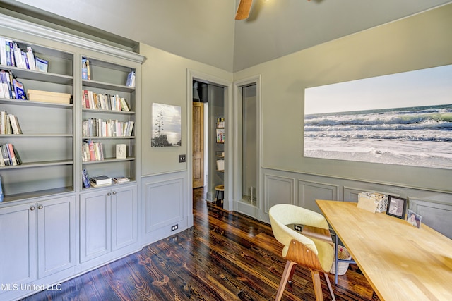 office space featuring wainscoting, vaulted ceiling, ceiling fan, and dark wood-style flooring