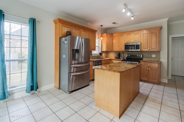 kitchen featuring light tile patterned floors, dark stone countertops, stainless steel appliances, a center island, and decorative light fixtures