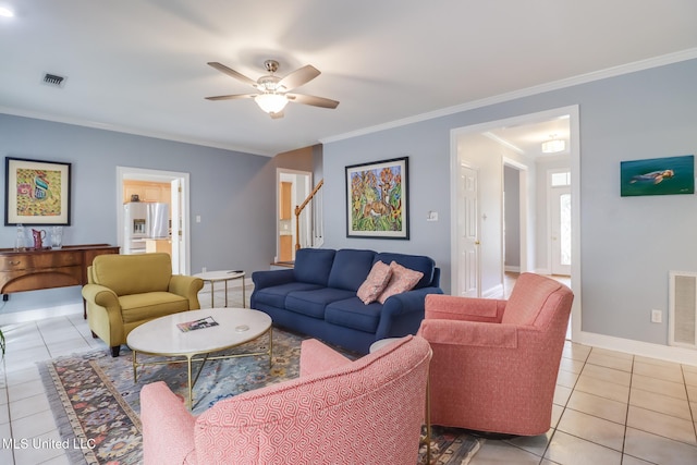 living room with crown molding, ceiling fan, and light tile patterned floors