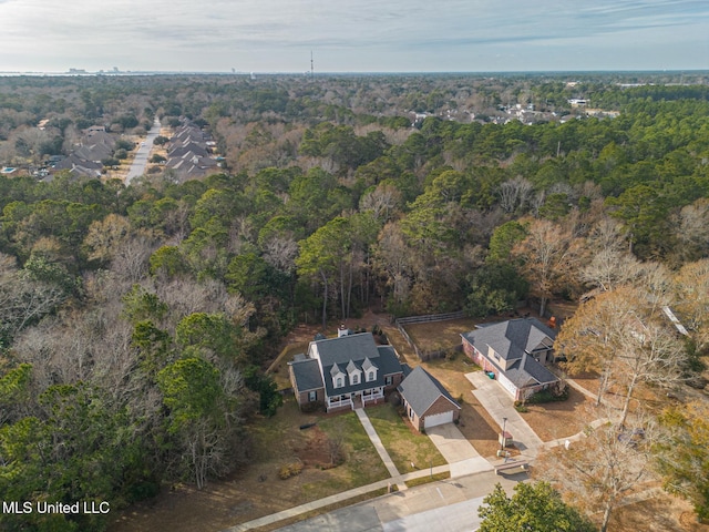 birds eye view of property with a view of trees