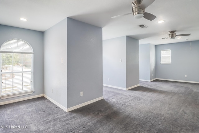 carpeted empty room featuring ceiling fan