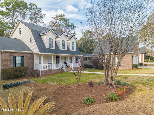 cape cod-style house with a gambrel roof, covered porch, a front yard, and a shingled roof