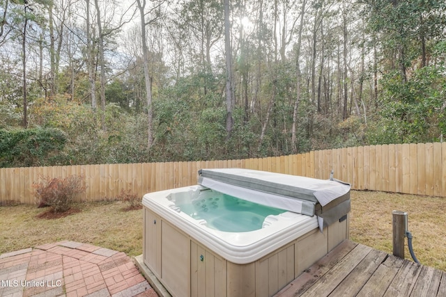 wooden terrace with a hot tub