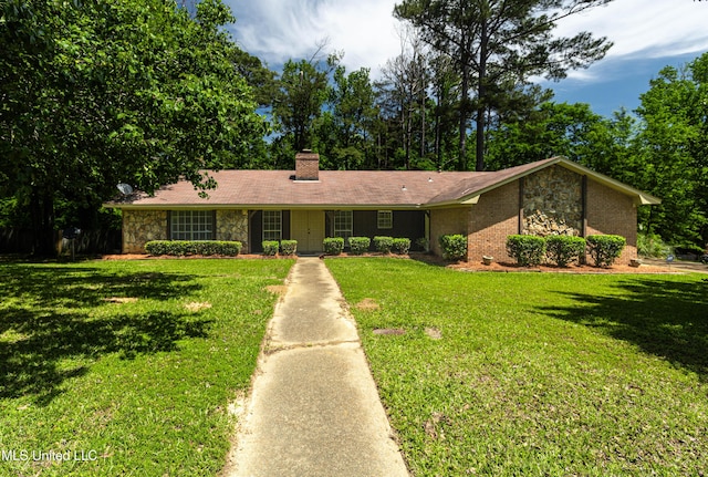 ranch-style home with a chimney, a front lawn, and stone siding