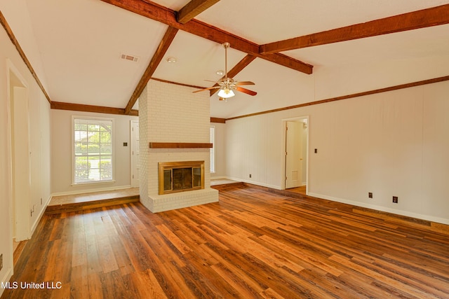 unfurnished living room with a ceiling fan, visible vents, a fireplace, wood finished floors, and lofted ceiling with beams