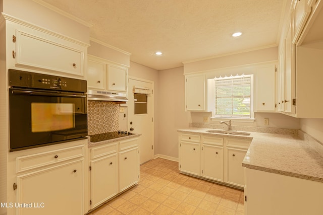 kitchen with light floors, recessed lighting, under cabinet range hood, a sink, and black appliances