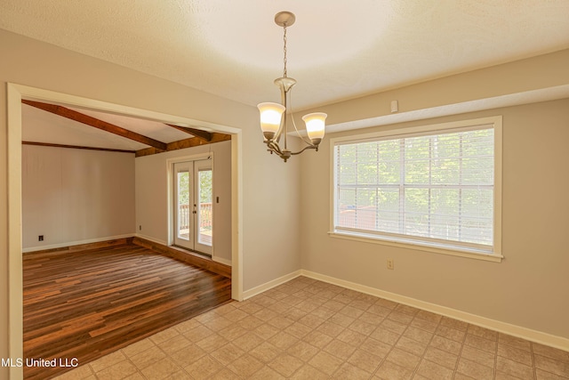 unfurnished room with an inviting chandelier, baseboards, beamed ceiling, and light floors