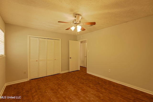 unfurnished bedroom with a closet, wood finished floors, baseboards, a textured ceiling, and a ceiling fan