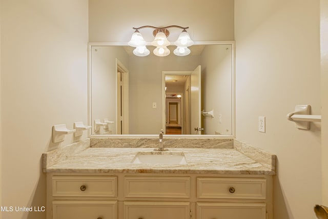 bathroom with a chandelier and vanity