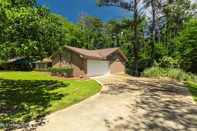 view of front facade with brick siding, driveway, a front yard, and a garage