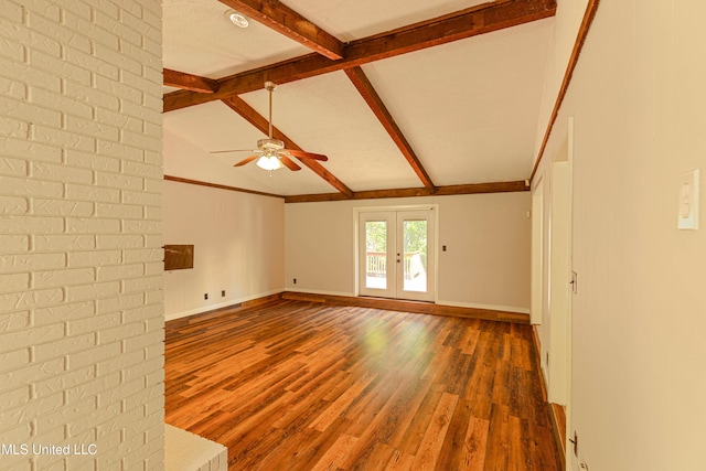empty room with baseboards, lofted ceiling with beams, a ceiling fan, and wood finished floors