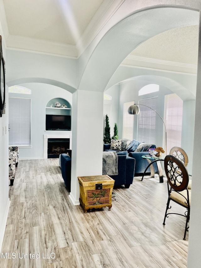 2252 Beach Dr Unit 305, Gulfport, MS 39507 - hallway featuring ornamental molding, arched walkways, wood finished floors, and built in features