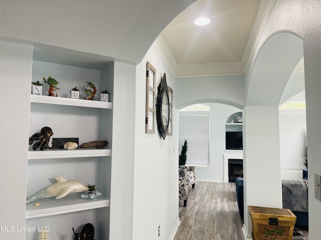 2252 Beach Dr Unit 305, Gulfport, MS 39507 - hall with built in shelves, crown molding, arched walkways, wood finished floors, and baseboards