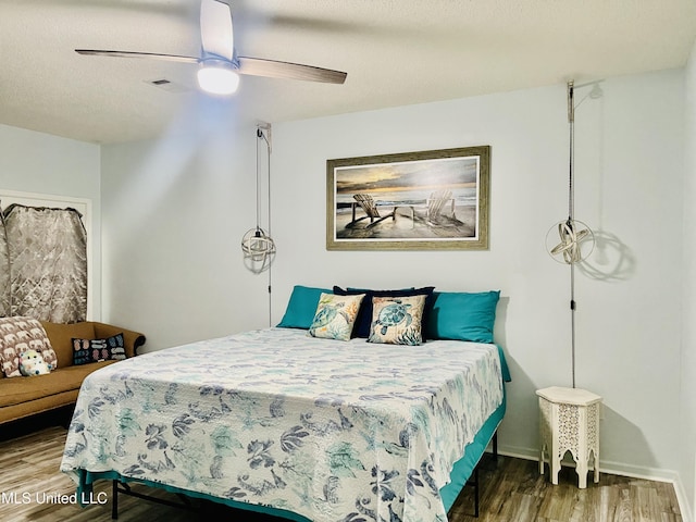 2252 Beach Dr Unit 305, Gulfport, MS 39507 - bedroom featuring wood finished floors, a ceiling fan, and baseboards