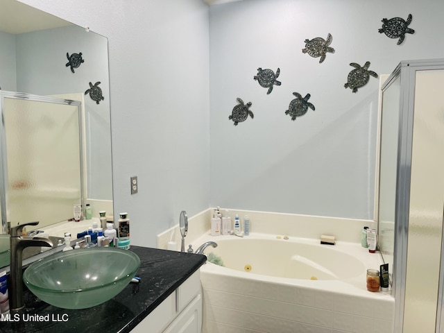 2252 Beach Dr Unit 305, Gulfport, MS 39507 - full bathroom featuring a jetted tub, a stall shower, and vanity